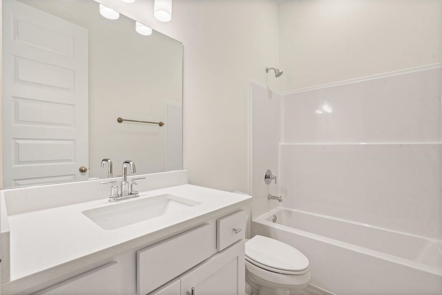 Vanity featuring a rectangular undermount sink and a white countertop Vanity featuring a rectangular undermount sink and a white countertop