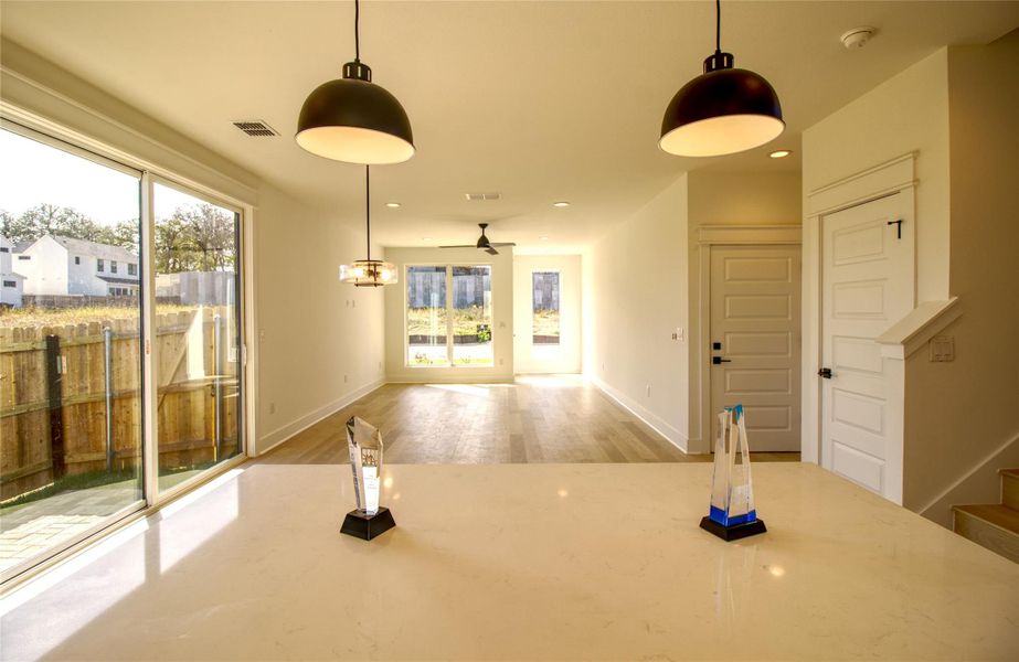 Unfurnished dining area featuring wood finished floors, stairway, recessed lighting, and ceiling fan
