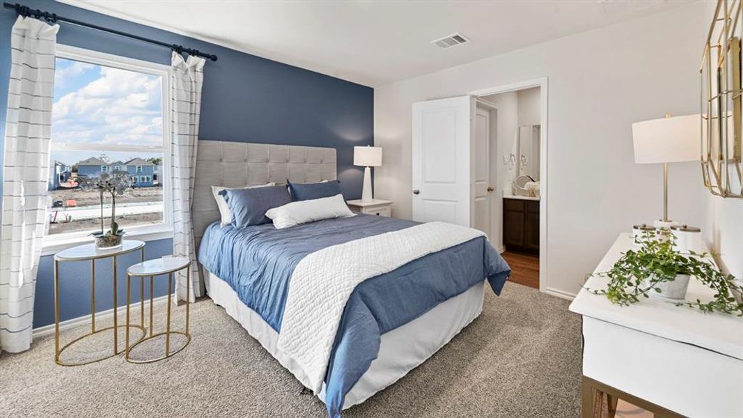 Bedroom featuring carpet floors and ensuite bathroom