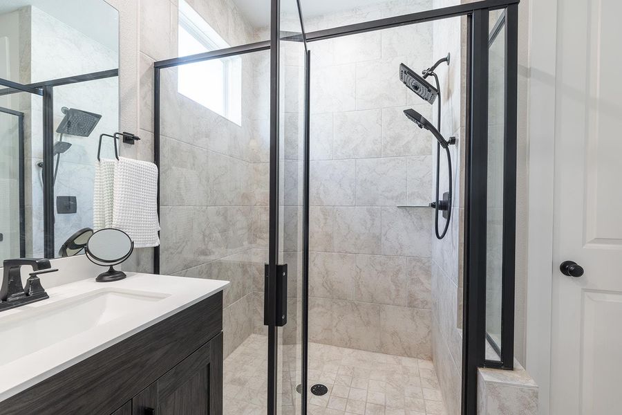 Bathroom featuring vanity and a stall shower