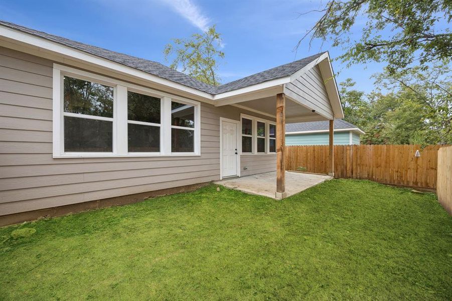 Rear view of house with a patio area Rear view of house with a patio area