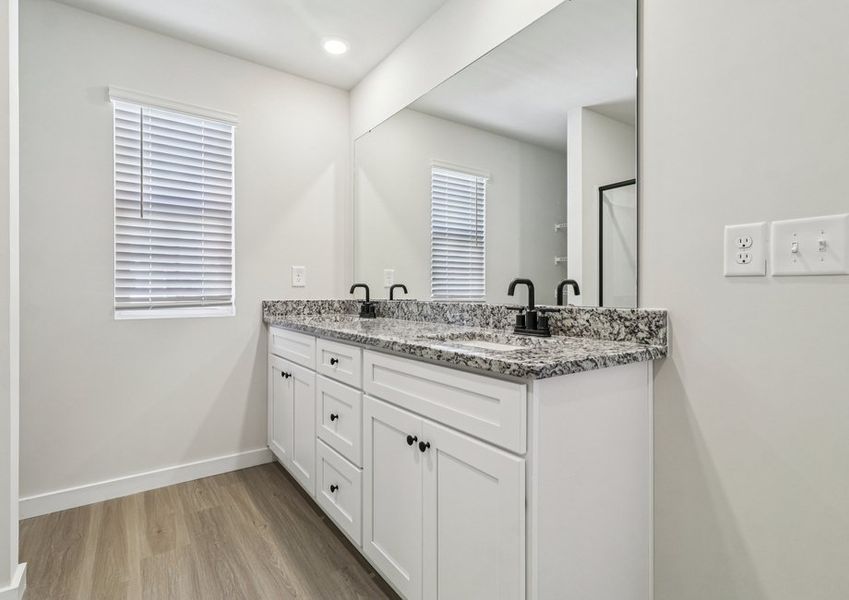 The master bathroom has a glass-enclosed shower