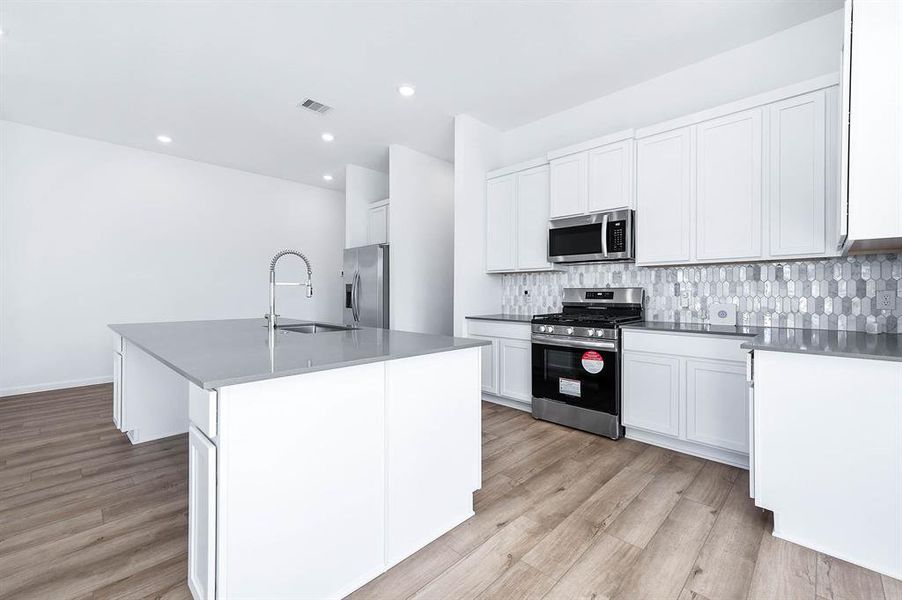 The heart of the home! This oversized island is perfect for meal prep, dining, or simply enjoying time with loved ones in this gorgeous modern kitchen.