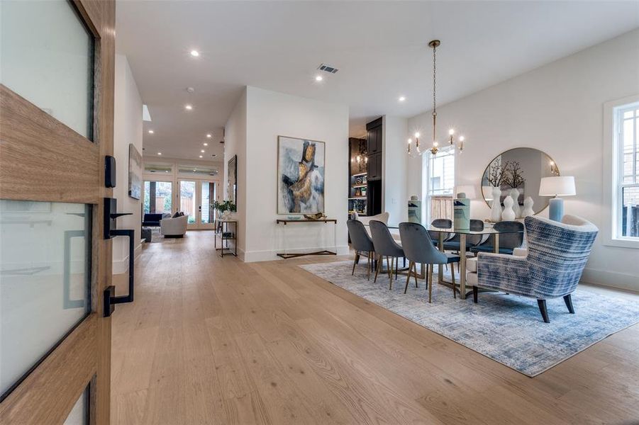 Dining area featuring visible vents, baseboards, light wood finished floors, a notable chandelier, and recessed lighting Dining area featuring visible vents, baseboards, light wood finished floors, a notable chandelier, and recessed lighting