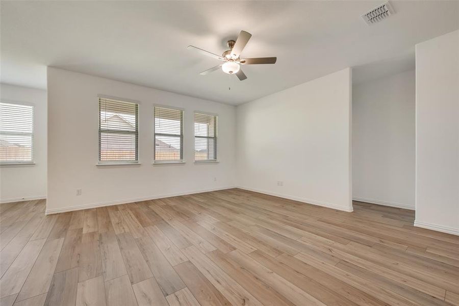 Spare room with light wood-type flooring and ceiling fan