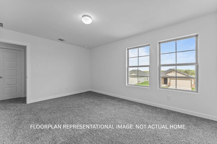 Natural light streams into this generously sized room, ready for your personal touch.