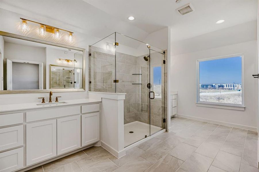 Bathroom featuring vanity, a shower stall, and recessed lighting