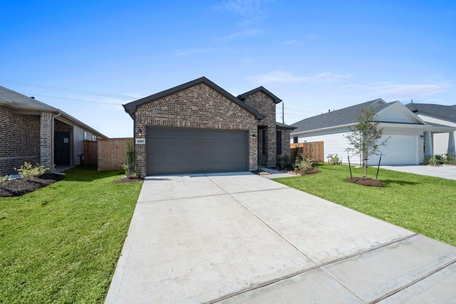 Front exterior of a new home in Crosby Farms, Crosby, TX, highlighting curb appeal (Image 1).