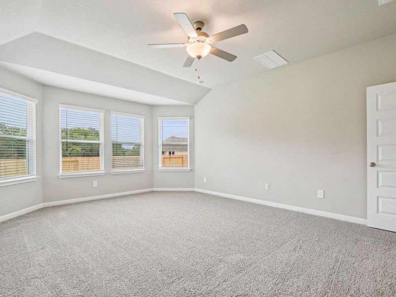 Unfurnished room featuring carpet flooring, a ceiling fan, and lofted ceiling Unfurnished room featuring carpet flooring, a ceiling fan, and lofted ceiling