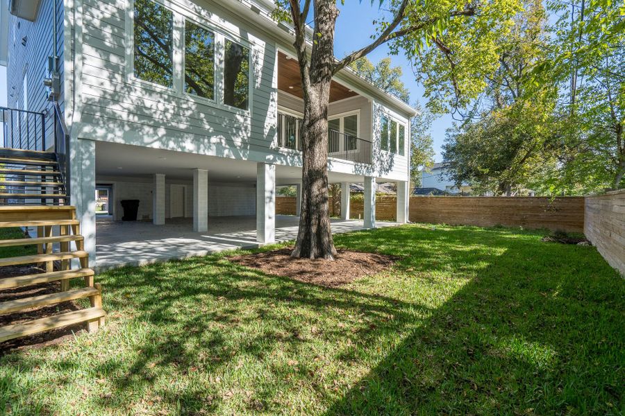 Spacious yard with wood fencing, elevated porch, and covered lower level for parking, storage, entertaining and future kitchen build-out. Spacious yard with wood fencing, elevated porch, and covered lower level for parking, storage, entertaining and future kitchen build-out.