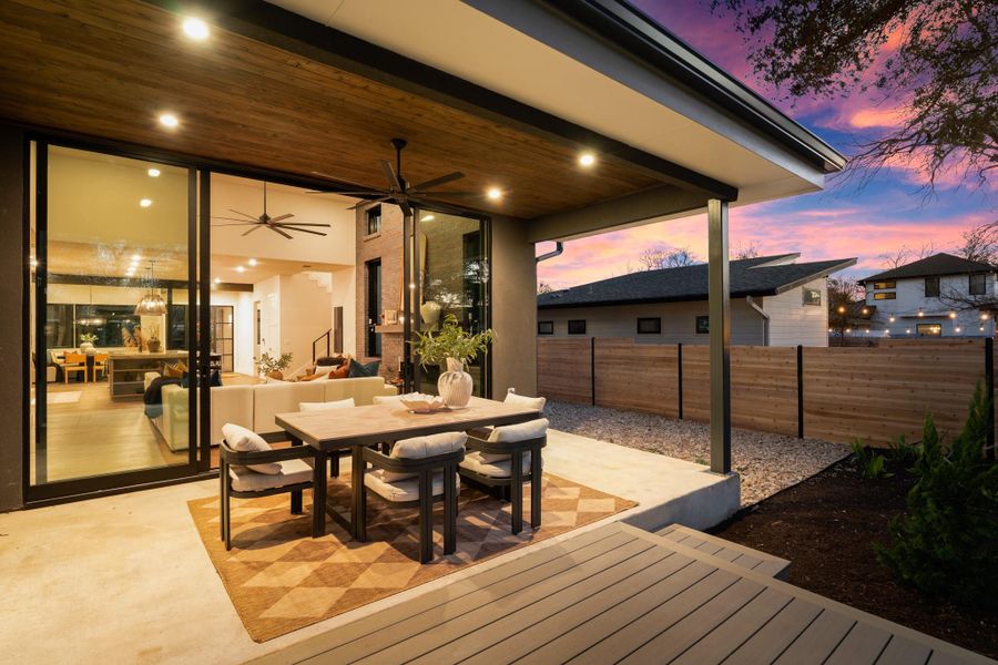 Deck at dusk featuring a patio, outdoor dining space, and a ceiling fan