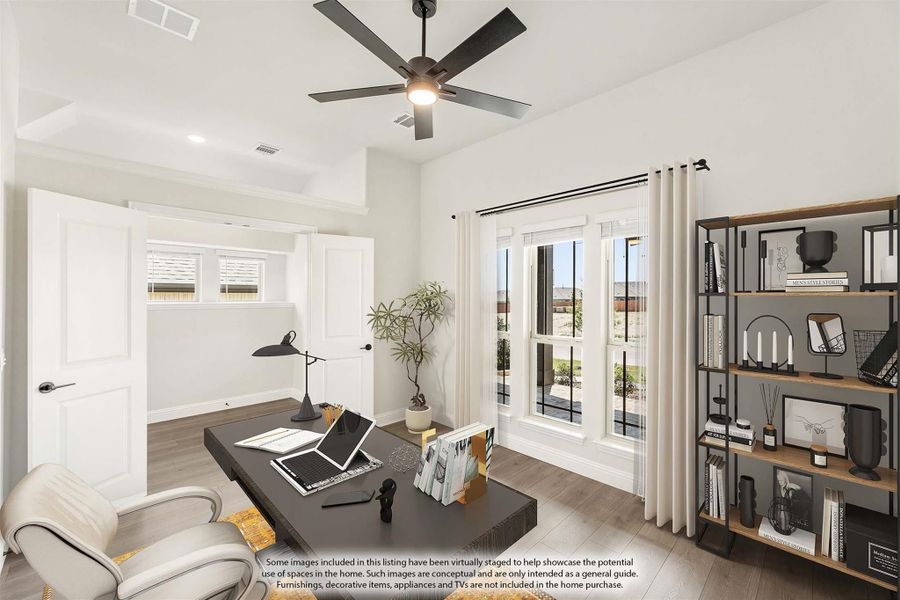 Home office with ceiling fan, dark desk, open shelving unit, and large windows with natural light Home office with ceiling fan, dark desk, open shelving unit, and large windows with natural light