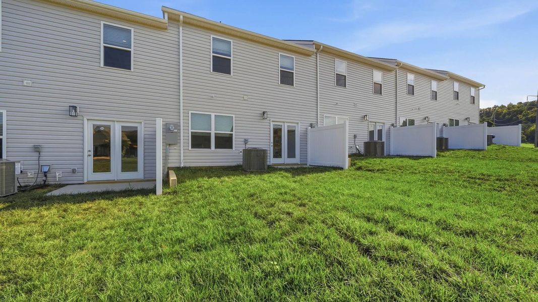 Exterior details and patio area of a home in The Arbor Townhomes, Kingsport (Image 17).