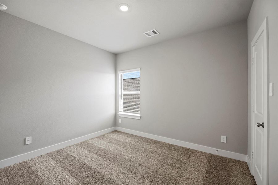 Three spacious secondary bedrooms upstairs, each with large closets and cozy carpet underfoot.