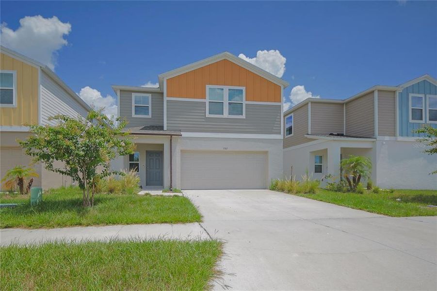 Front exterior of a new home in Pasadena Point, Wesley Chapel, FL, highlighting curb appeal (Image 24). Front exterior of a new home in Pasadena Point, Wesley Chapel, FL, highlighting curb appeal (Image 24).