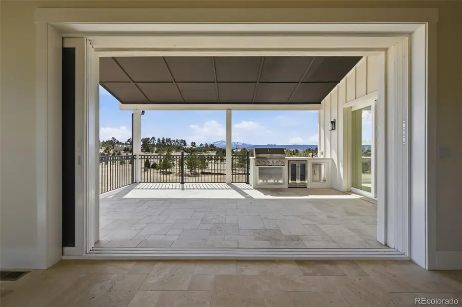 View from Great Room to covered patio and outdoor kitchen View from Great Room to covered patio and outdoor kitchen