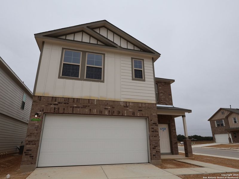 Front exterior of a new home in Winding Brook, San Antonio, TX, highlighting curb appeal (Image 21).