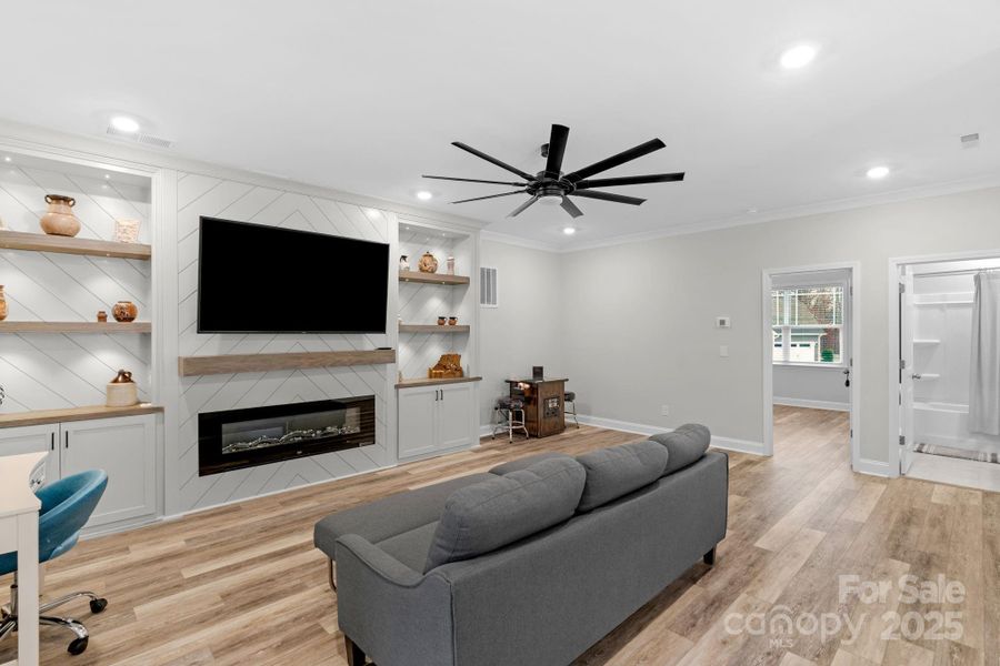 2nd floor loft/recreation room with built-ins and electric fireplace