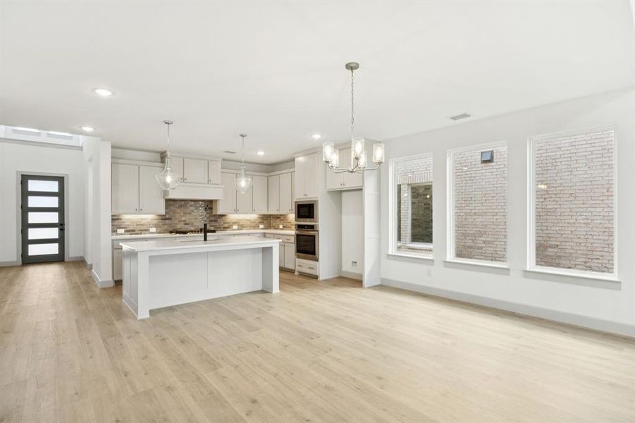 Featuring a view to the outdoors through a wall of windows, this dining room is the perfect setting for lively dinner parties or cozy family meals! Featuring a view to the outdoors through a wall of windows, this dining room is the perfect setting for lively dinner parties or cozy family meals!