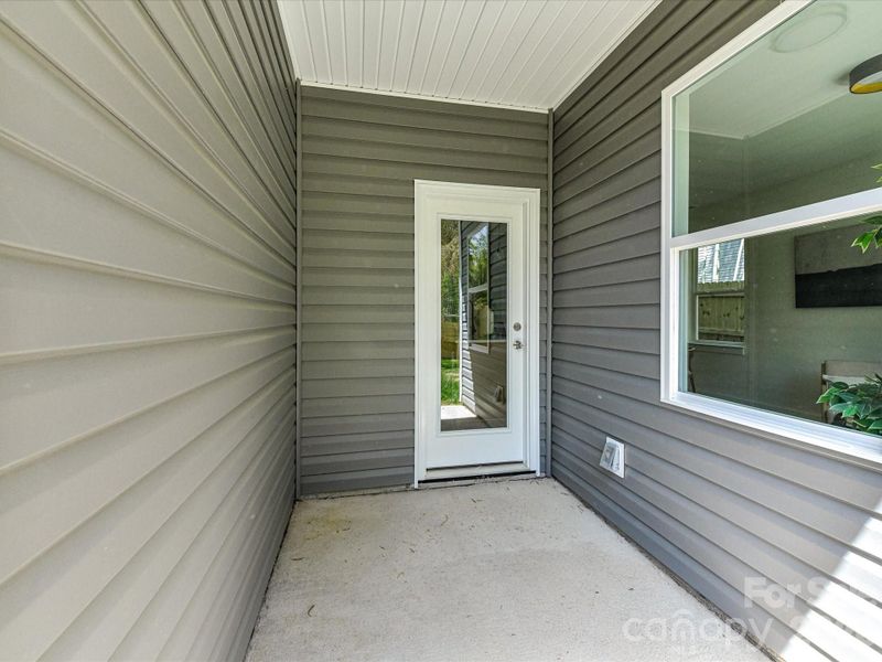Covered patio overlooks a private fenced backyard, creating the perfect setting for outdoor dining, relaxing, or entertaining year-round.