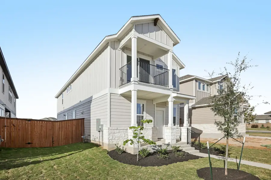 A white house with a fence.