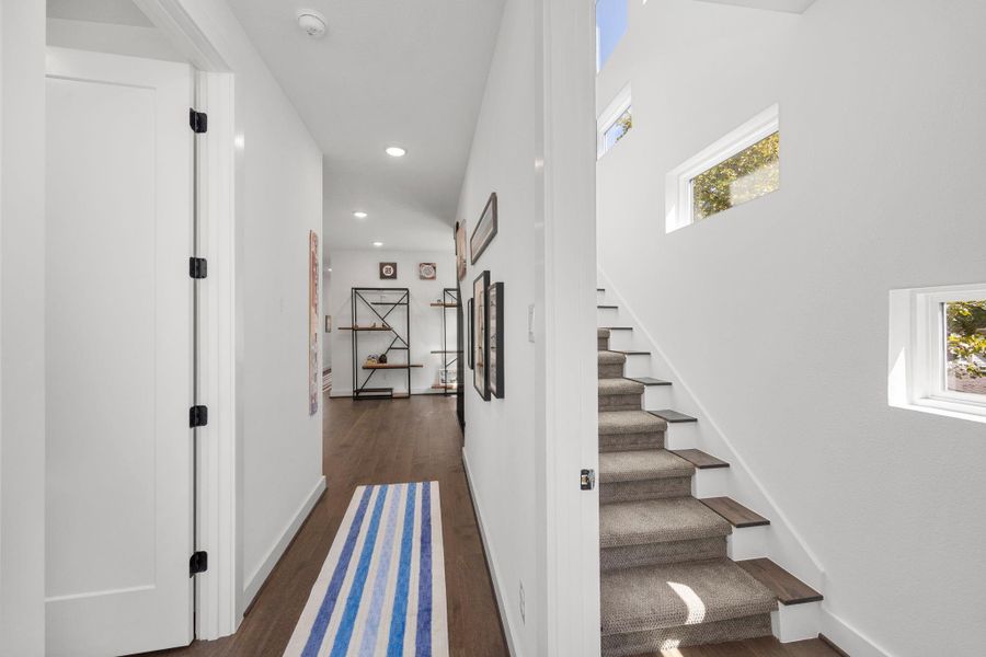 Stairway to third floor. Wall of windows as you walk up.