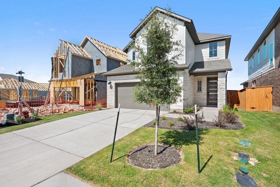 Front exterior of a new home in Terrace Collection at Lariat, Liberty Hill, TX, highlighting curb appeal (Image 17). Front exterior of a new home in Terrace Collection at Lariat, Liberty Hill, TX, highlighting curb appeal (Image 17).
