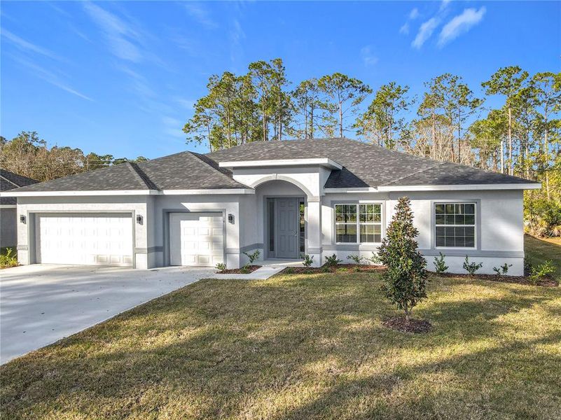 Front exterior of a new home in , Palm Coast, FL, highlighting curb appeal (Image 25). Front exterior of a new home in , Palm Coast, FL, highlighting curb appeal (Image 25).