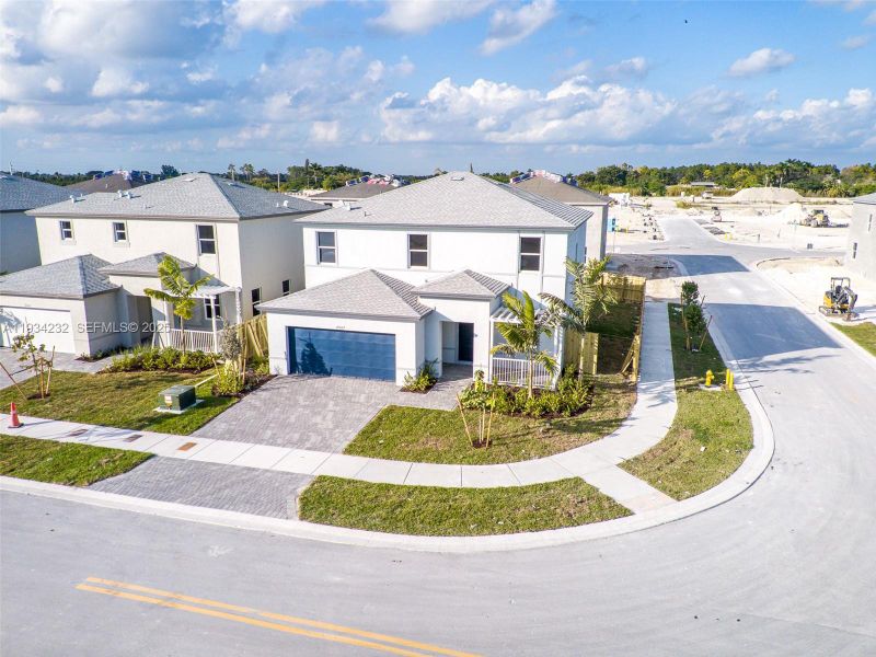 Front exterior of a new home in Acacia Groves, Miami, FL, highlighting curb appeal (Image 22).