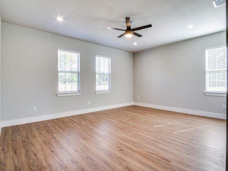 Unfurnished room with light wood-type flooring and ceiling fan