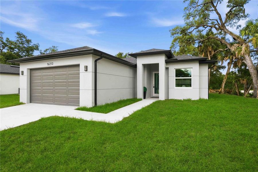 Front exterior of a new home in , Port Charlotte, FL, highlighting curb appeal (Image 26).