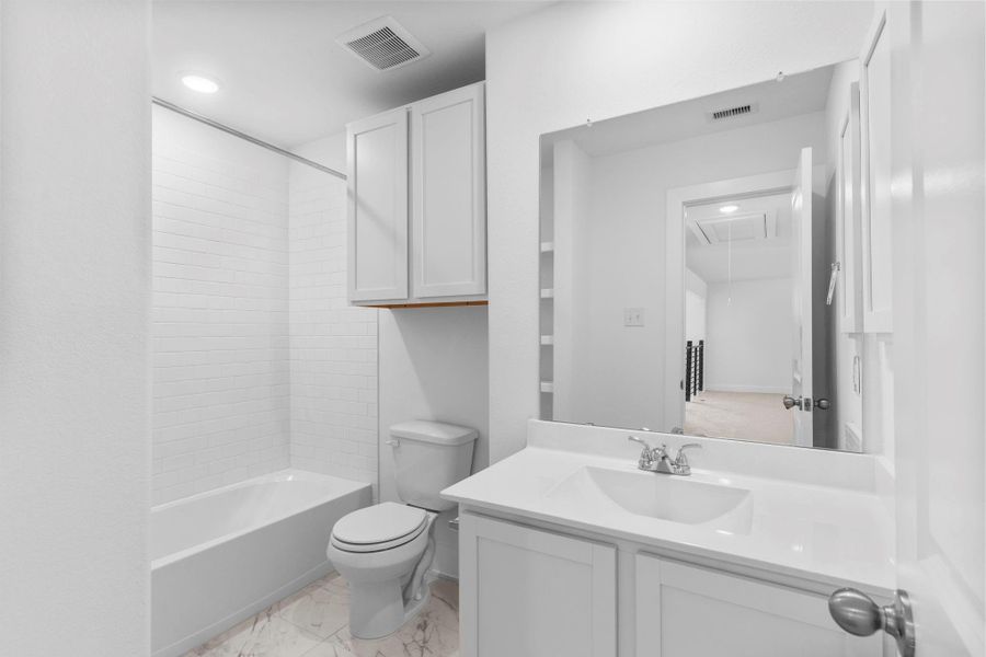 Full upstairs bathroom complete with a tub/shower combo, extended vanity, and modern fixtures — call now to schedule your private tour! **Image Representative of Plan Only and May Vary as Built**.
