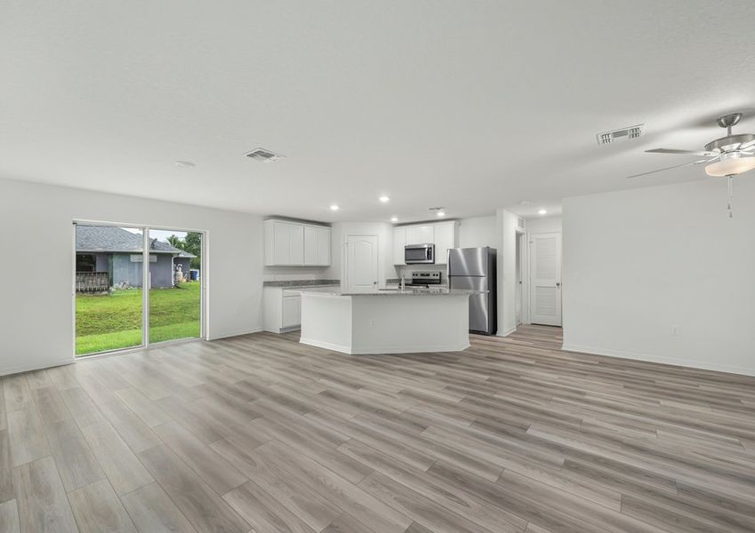 The family room is spacious and has a sliding glass door leading to the backyard