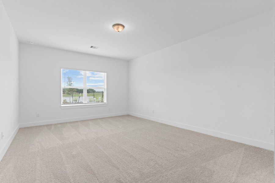 The serene primary bedroom is tucked away on the first floor and features plush carpeting, a large window with backyard views, and plenty of space for a king-sized bed and furnishings. What a view of the lake to start you day! The serene primary bedroom is tucked away on the first floor and features plush carpeting, a large window with backyard views, and plenty of space for a king-sized bed and furnishings. What a view of the lake to start you day!