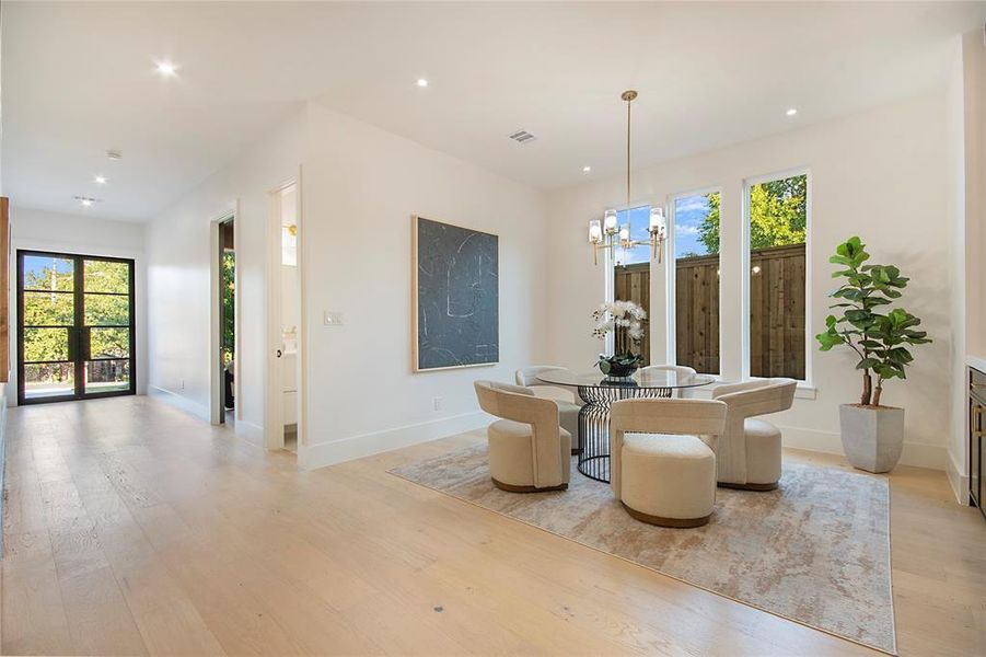Dining area with light wood-style floors, recessed lighting, and a chandelier Dining area with light wood-style floors, recessed lighting, and a chandelier