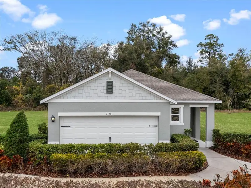 Front exterior of a new home in Harmony West, St. Cloud, FL, highlighting curb appeal (Image 1).
