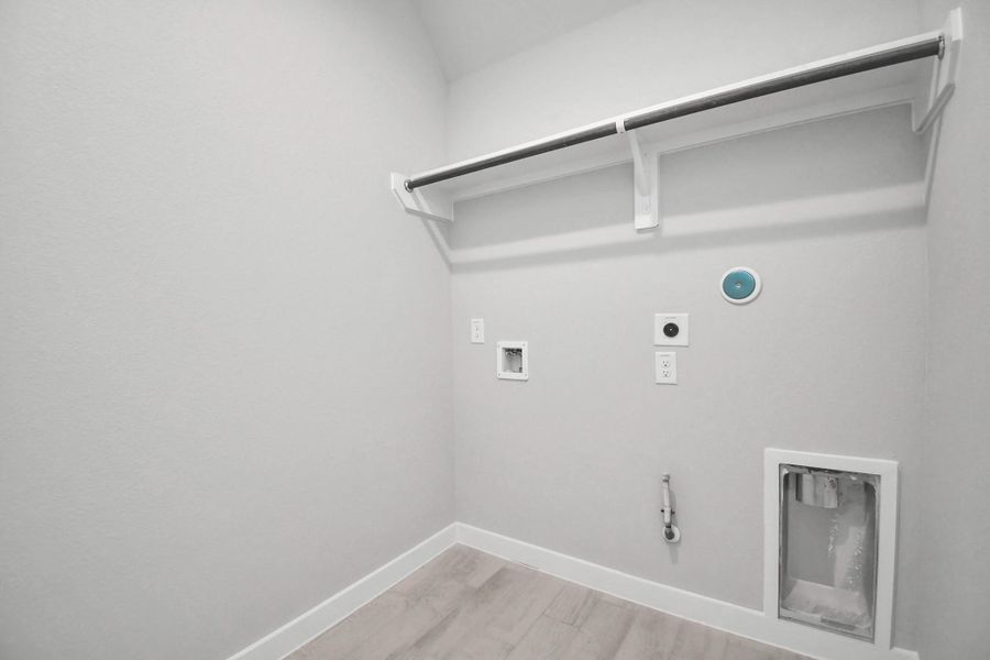 A perfect blend of functionality and comfort. Capture the essence of easy living with a first-floor laundry room, thoughtfully equipped with shelving for effortless organization. Both electric and gas connections available. A perfect blend of functionality and comfort. Capture the essence of easy living with a first-floor laundry room, thoughtfully equipped with shelving for effortless organization. Both electric and gas connections available.