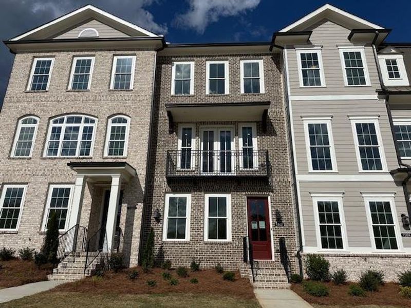 Front exterior of a new home in Waterhaven, Cumming, GA, highlighting curb appeal (Image 2). Front exterior of a new home in Waterhaven, Cumming, GA, highlighting curb appeal (Image 2).