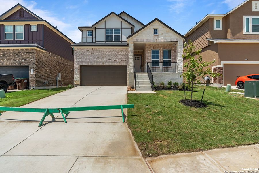 Front exterior of a new home in Hunters Ranch, San Antonio, TX, highlighting curb appeal (Image 28).