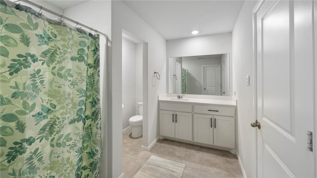 Bathroom with a shower with shower curtain, vanity, recessed lighting, and light tile patterned floors