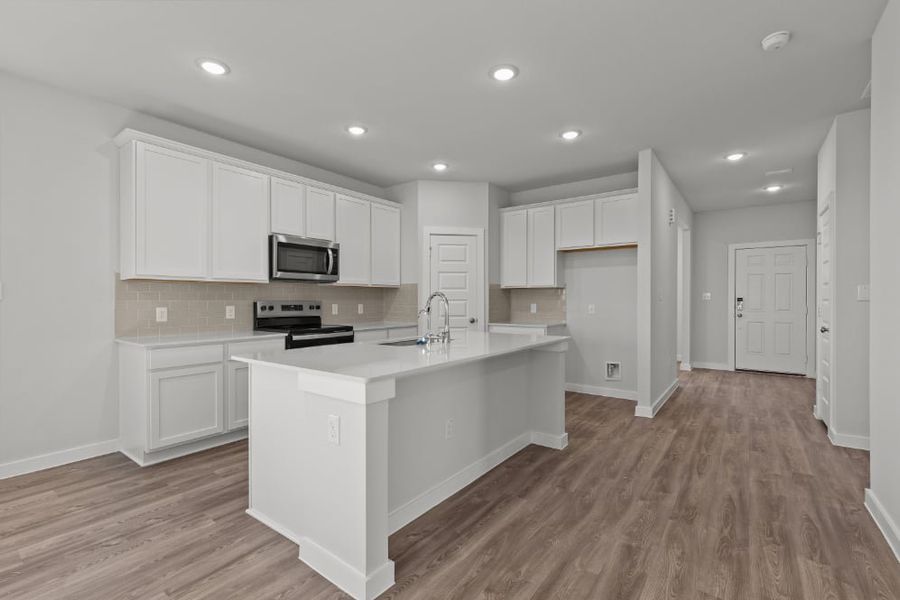 A kitchen with white cabinets.