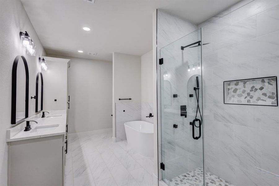 Bathroom featuring shower with separate bathtub and vanity