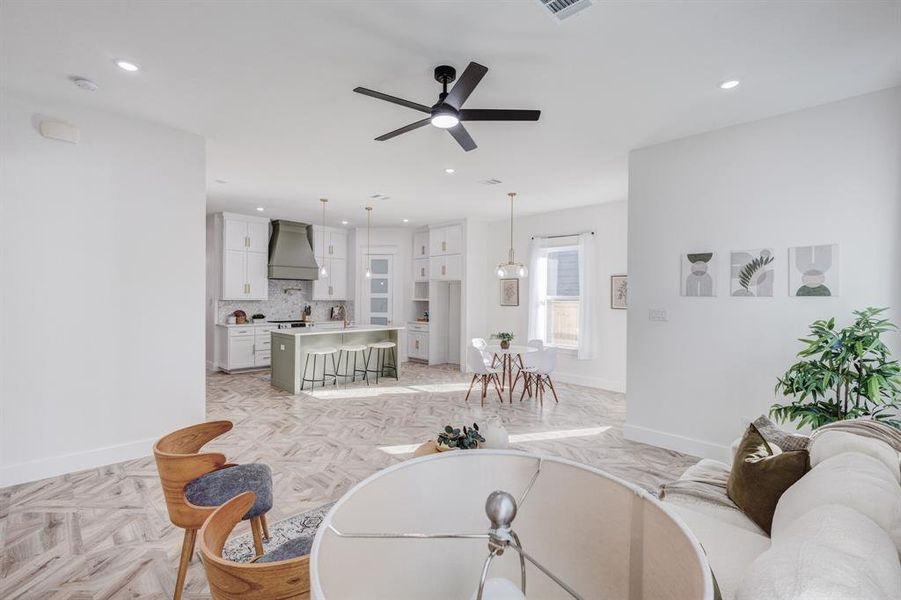 Living room featuring light parquet flooring and ceiling fan