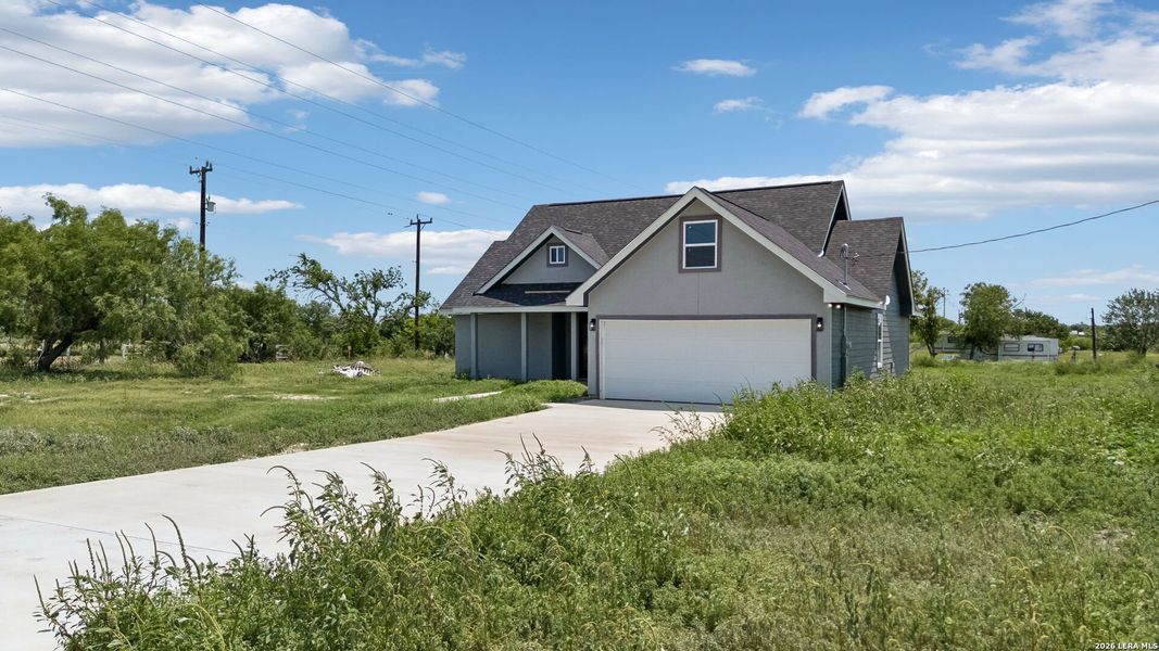 Front exterior of a new home in , Natalia, TX, highlighting curb appeal (Image 17).
