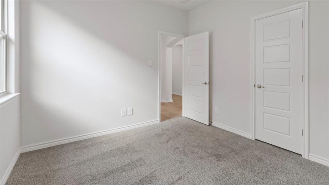 Unfurnished bedroom featuring carpet floors and baseboards