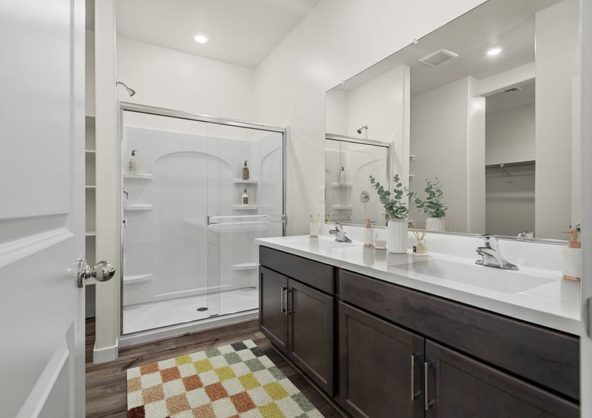 The master bathroom features a glass-enclosed shower and luxurious upgrades.