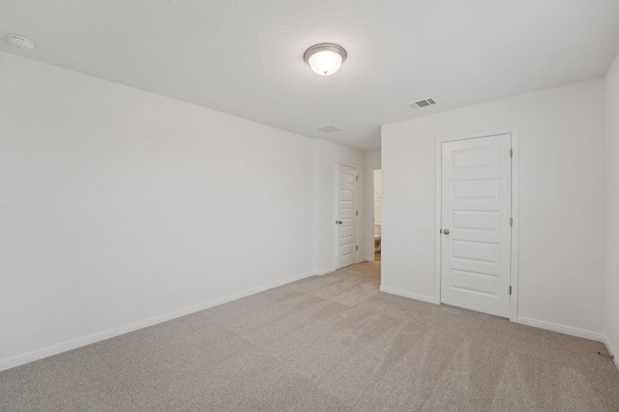 Spare room featuring light colored carpet and baseboards