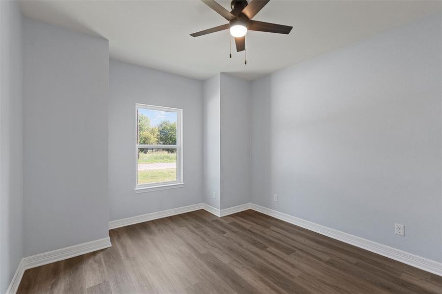 Unfurnished room featuring wood finished floors and ceiling fan