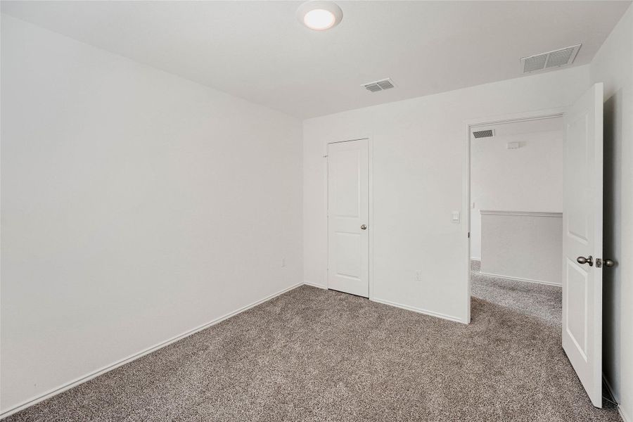 Bedroom #2 featuring a ceiling-mounted light fixture, white walls, and white baseboards Bedroom #2 featuring a ceiling-mounted light fixture, white walls, and white baseboards