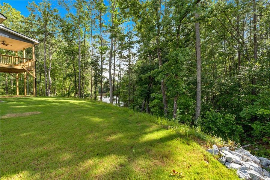 Front exterior of a new home in Palmer Falls, Douglasville, GA, highlighting curb appeal (Image 1).